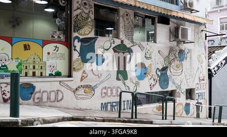 Affresco colorato a tema colazione e caffè su un muro di un edificio nella vecchia Macao, Cina Foto Stock