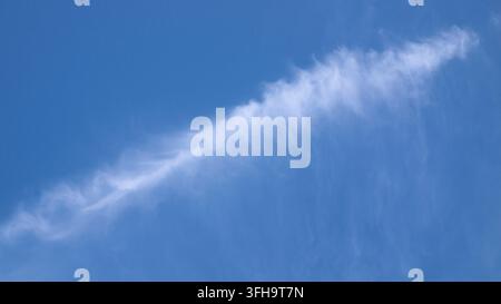 Formazione di nuvole bianche e sottili contro un cielo blu terso, sfondo meteorologico naturale Foto Stock