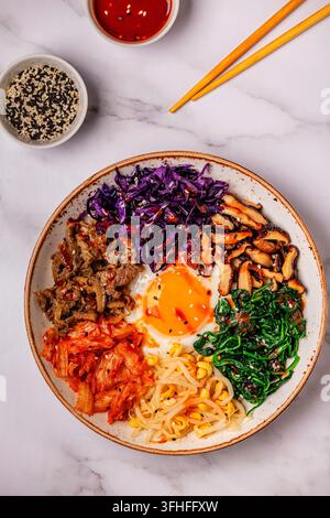 Bibimbap con verdure colorate, manzo e uovo in una ciotola Foto Stock