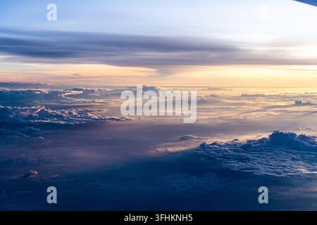 Affascinante veduta aerea di nuvole e cielo all'alba, che mostra bellissime colori e motivi sull'orizzonte Foto Stock