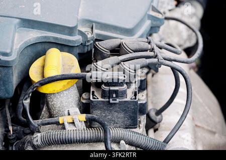Vano motore dell'auto con tappi di servizio gialli e tubi. Sfondo automobilistico per la manutenzione, l'ispezione del motore, la riparazione e il servizio del veicolo. Foto Stock