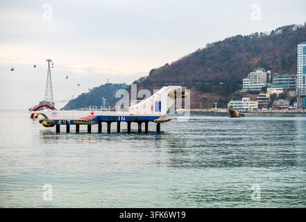 Busan, Corea del Sud - 14 febbraio 2026: Vista del molo a forma di tartaruga alla stazione di Songdo Bay con il sistema di teleferica sullo sfondo. Foto Stock