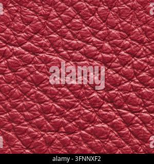 Scatto macro dettagliato di una ricca superficie in pelle cremisi con una texture granosa a ciottoli distinta e un motivo tattile sbozzato con lig dimensionale morbida Foto Stock
