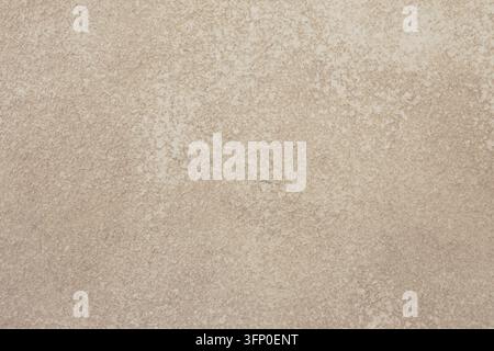 Primo piano di un muro esterno di colore beige chiaro o crema con finitura in stucco float sabbia fine e un motivo strutturato sottile. Foto Stock