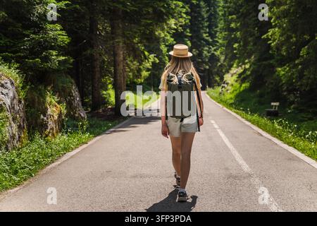 Un'escursionista femminile cammina lungo una strada forestale nel Parco Nazionale del Durmitor, Montenegro. Foto Stock