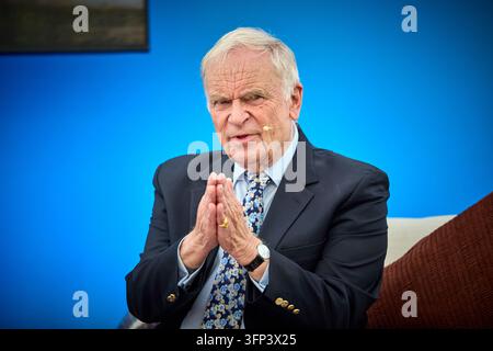 Jeffrey Archer al Queen’s Reading Festival durante l’autografo dei suoi libri Foto Stock