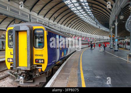 Northern Trains Class 156 Super Sprinter in livrea viola e gialla al binario della stazione centrale di Newcastle Foto Stock