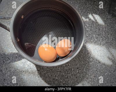 Due uova sode in una pentola; Foto Stock