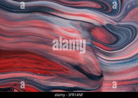 Texture liquida astratta con flussi che scorrono nei colori rosso, blu scuro e bianco Foto Stock