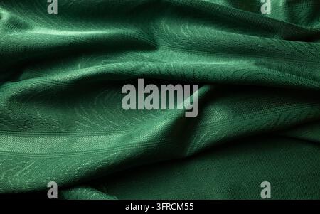 Tessuto verde smeraldo scuro con pieghe eleganti e fluide e una trama sottile Foto Stock