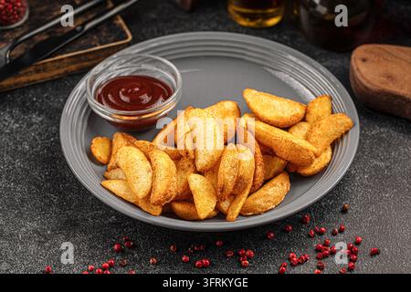 Spiedini di patate con salsa su piatto grigio Foto Stock