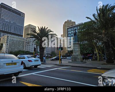CAPO TOWN - NOV 28, 2023: Via cittadina affollata con un semaforo e una statua. Ci sono molte auto sulla strada, compresa una Mercedes bianca a Città del Capo in Sudafrica Foto Stock