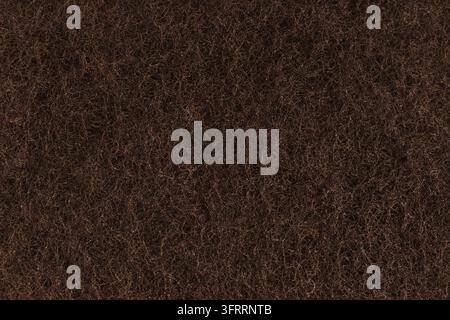 Texture astratta di feltro marrone con fibre dense, struttura soffice di moquette o erba artificiale in primo piano, macro. Superficie tessile, materiale per lo sport Foto Stock