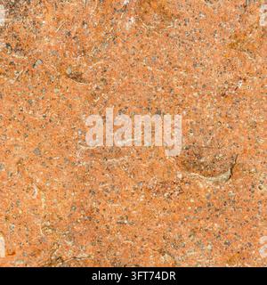 Prima piano di una texture superficiale in pietra ruvida arancione e rossa con minuscoli ciottoli incastonati, uno sfondo roccioso naturale per l'uso nel design. Foto Stock