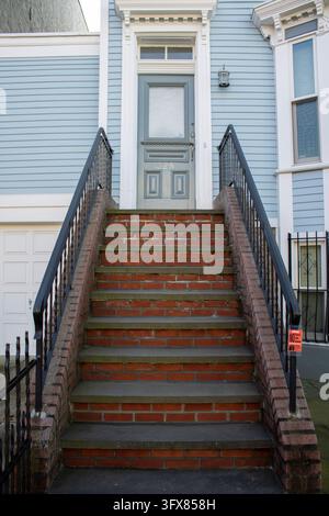 Brooklyn, NY – 9 dic. 2023: Casa in arenaria blu chiaro con una scala anteriore e recinzioni in autunno, il numero 328 sulla porta, Brooklyn. Foto Stock