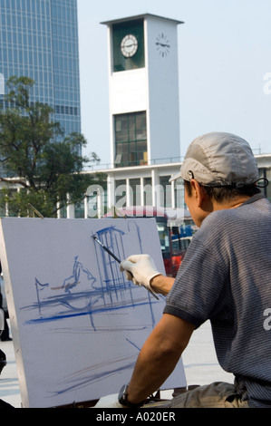 L'uomo pittura antica torre dell'orologio di Star Ferry piers nel centro poco prima furono demoliti per riconvertire 2006 Foto Stock