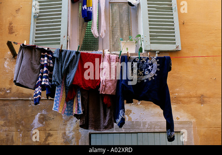 Lavaggio e asciugatura appeso al di fuori su una linea di abbigliamento in una strada nel sud della Francia Foto Stock