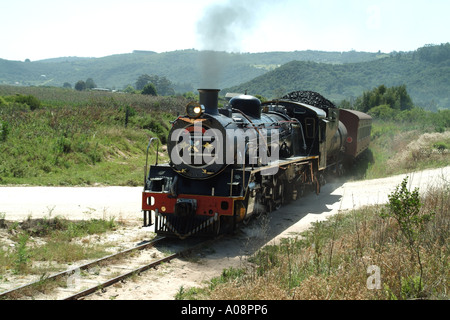 Di Outeniqua Choo Tjoe treno a vapore in ambiente rurale vicino al deserto di Western Cape South Africa RSA passa attraversamento senza equipaggio Foto Stock