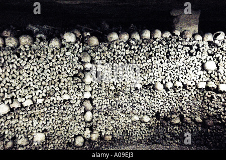 Pile di teschi umani e le ossa in catacombe Parigi Francia Foto Stock