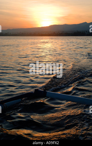 Alba sul Outrigger barca da pesca al largo della costa di Lovina e Singaraja, nord di Bali, Indonesia Foto Stock