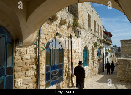 Israele Galilea superiore di Safed Città Vecchia strada tipica scena con ebrei ortodossi a piedi da e arco in frgd Foto Stock