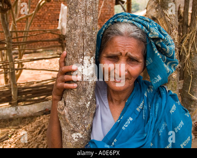 Grigio di un villaggio dai capelli donna tribale in Orissa pone con un sorriso divertito Foto Stock