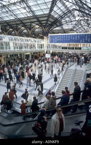 Londra, Inghilterra. La folla di persone a Liverpool Street station; scale mobili; segni. Foto Stock