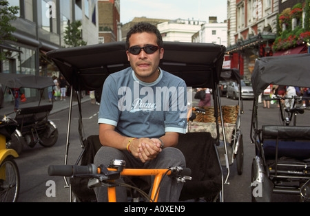 Regno Unito, Inghilterra, Londra. Pedicab driver a Covent Garden Foto Stock