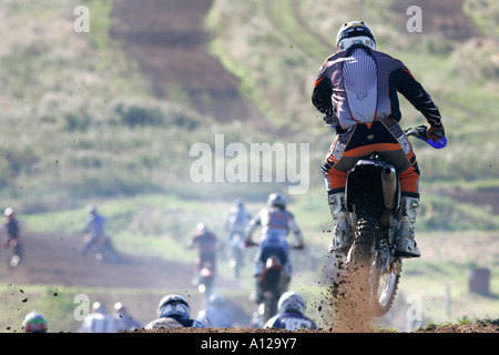 Rider butta il fango e la sporcizia che va oltre la terra salta durante la gara a tandragee circuito di motocross contea di Down Irlanda del Nord Foto Stock