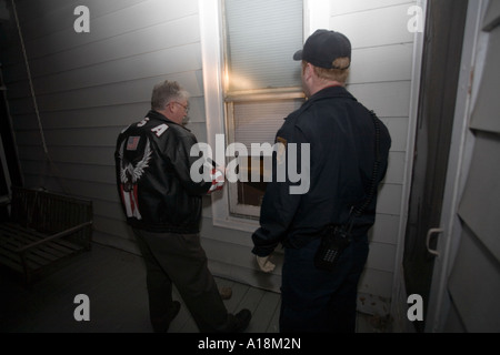 Scena del Crimine tecnico e Detective ispezionano il vetro rotto sulla scena di un furto con scasso Kansas City MO criminalità polizia Lab Foto Stock