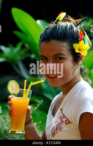 Ragazza con un succo di arancio durante la vacanza in Thailandia, Tailandia Foto Stock