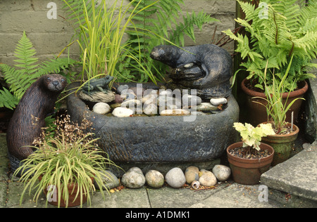 Giardino trogolo ptone utilizzato come una funzione di acqua con statue di lontra Foto Stock