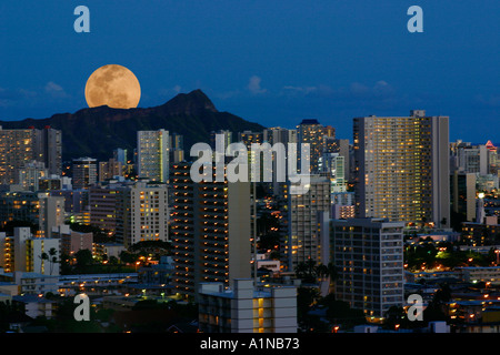 La luna piena si elevano al di sopra della Diamond Head di Waikiki skyline al tramonto Honolulu Oahu Hawaii Foto Stock