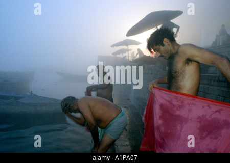 Gli uomini prendere un bagno di religiosi per pulire le loro anime dai peccati passati nel sacro Gange nella città di Varanasi in India del nord Foto Stock