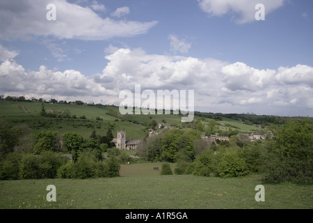 Una tipica vista Inglese guardando sopra il villaggio Costwold di Naunton accanto al Fiume Windrush su una giornata d'estate Foto Stock