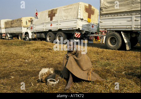 GOMA DELLO ZAIRE LA CROCE ROSSA LA DISTRIBUZIONE DI AIUTI ALIMENTARI PER I RIFUGIATI RUANDESI KIBUMBA CAMP LUGLIO 1994.Il rifugiato in attesa al di sotto di una coperta. Foto Stock