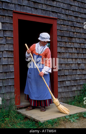 1, una donna canadese, indossando il costume, SPAZZAMENTO, Acadian Historical Village, vicino alla città di Caraquet, New Brunswick Provincia, Canada Foto Stock