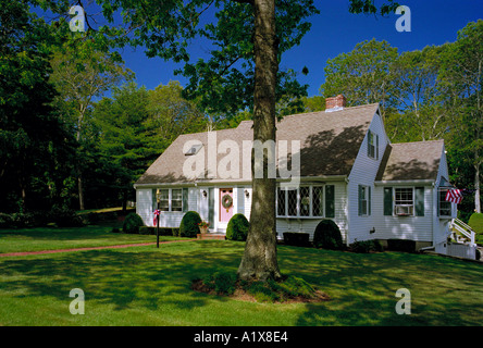 Un clapboard rivestito di legno casa tra gli alberi su Cape Cod Massachusetts USA decorato per il 4 di luglio Foto Stock