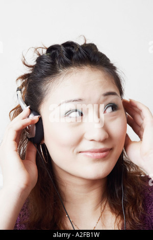 Close-up di una giovane donna di ascolto di musica Foto Stock