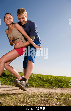 Coppia giovane jogging, uomo donna di cattura Foto Stock