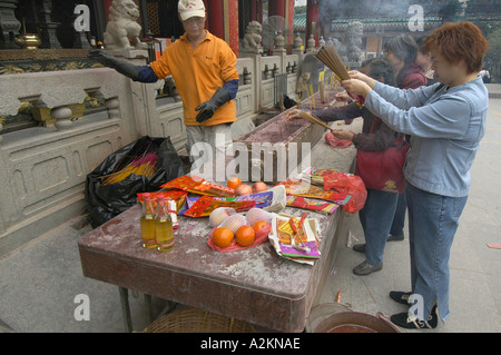 I credenti pregano e sacrificare a Wong Tai Sin tempel Foto Stock
