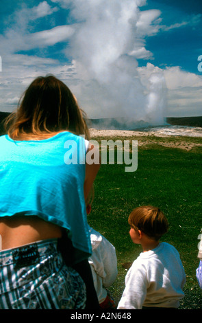 Parco i visitatori guarda geyser Old Faithful Parco Nazionale di Yellowstone Wyoming USA Foto Stock