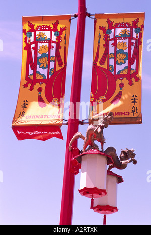 Banner e dragone cinese scultura sopra le luci di strada su un palo della luce in Chinatown, Vancouver, BC, British Columbia, Canada Foto Stock