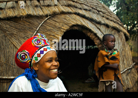 Zulu donna in rosso tradizionale copricapo di una donna sposata con bambini modello rilasciato in Sud Africa Foto Stock