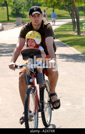 Padre e figlia giovane su una bicicletta singolo Foto Stock