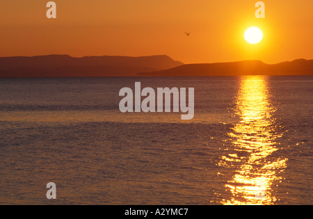 Regolazione del sole e di riflessioni oltre oceano Atlantico con costa orientale del Canada a distanza Foto Stock