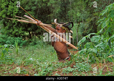 Huli boy tiro con arco e frecce nella foresta Tari Southern Highlands di Papua Nuova Guinea Foto Stock