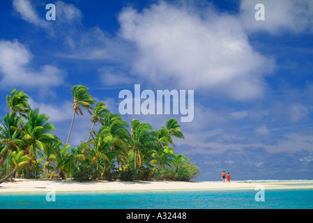 Paio di camminare sulla spiaggia con cielo blu oceano e isole Cook Foto Stock