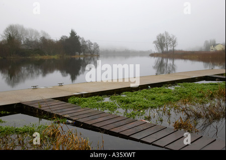 La pesca e il molo sul fiume Erne a Enniskillen in una nebbiosa giornata invernale Foto Stock