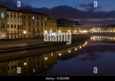 Edifici tradizionali si riflette nel fiume Arno a Pisa al crepuscolo/sera - preso dal Ponte di Mezzo (ponte centrale). Foto Stock